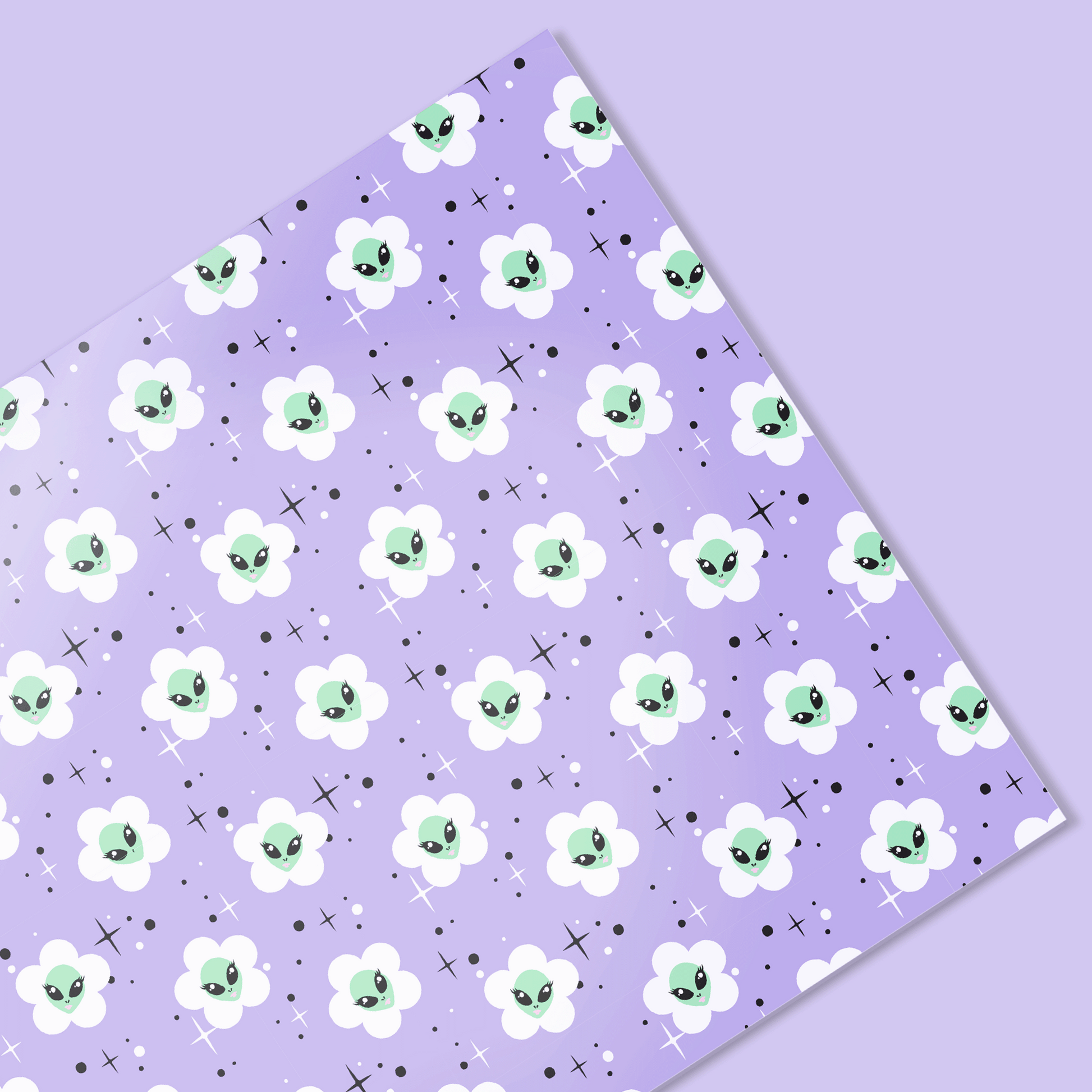 Floral patterned paper with cartoonish alien face flowers on a purple background